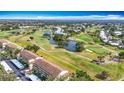 Expansive aerial shot of the condo community overlooking a meticulously maintained golf course and serene pond at 839 Wexford Blvd # 839, Venice, FL 34293