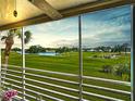 Scenic view of golf course and pond from the screened-in patio, perfect for relaxing and enjoying the outdoors at 839 Wexford Blvd # 839, Venice, FL 34293