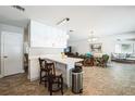 Open-concept living area with a kitchen island, dining space, and comfortable seating arrangement at 8432 Culebra Ave, North Port, FL 34287