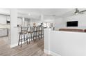Bright kitchen area with breakfast bar and seating, open to the living space with modern finishes at 915 Citrus Rd, Venice, FL 34293