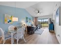 Inviting living and dining area with blue accents and access to a scenic balcony at 925 Capri Isles Blvd # 4, Venice, FL 34292