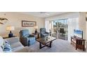 Bright living room featuring plush seating, and a sliding glass door to the screened lanai at 934 Wexford Blvd # 934, Venice, FL 34293