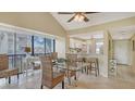 Cozy dining area with vaulted ceilings, stylish woven furniture, and serene natural light at 1130 Bird Bay Way # 184, Venice, FL 34285