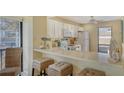 Kitchenette with white cabinetry, ample counter space, and decorative coastal accents at 1130 Bird Bay Way # 184, Venice, FL 34285