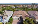 Overhead view of a single-story home with an attached garage and well-manicured landscaping at 11700 Tapestry Ln, Venice, FL 34293