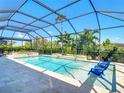 Relaxing screened-in pool area with sun-lounging chairs for luxurious outdoor living at 11700 Tapestry Ln, Venice, FL 34293