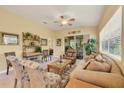 Inviting living room boasts a ceiling fan, comfortable seating, and sliding glass doors to an outdoor space at 121 Auburn Woods Cir, Venice, FL 34292