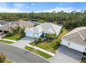 Aerial view of a well-manicured home with a two-car garage surrounded by lush landscaping at 12456 Destin Loop, Venice, FL 34293