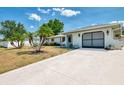 Well-kept home with a one-car garage and a lovely front yard with a nice, long driveway at 1281 Wilson Dr, Englewood, FL 34224