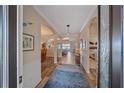 Welcoming foyer with arched doorways, wood floors, and views into the living spaces at 13215 Amerigo Ln, Venice, FL 34293