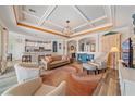 Spacious living room featuring coffered ceilings, stylish decor, and an open layout at 13215 Amerigo Ln, Venice, FL 34293