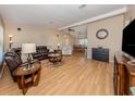 Spacious living room featuring hardwood floors, a ceiling fan, and view to the dining area at 1340 Olympia Rd, Venice, FL 34293