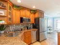Kitchen with stainless steel appliances, granite countertops, and beautiful custom wood cabinetry at 1440 Overbrook Rd, Englewood, FL 34223