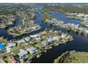 Stunning aerial view of a waterfront home with beautiful surroundings and direct access to waterways at 1503 Marlin St, Nokomis, FL 34275
