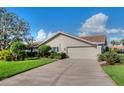 Spacious home featuring a two-car garage, concrete driveway and well manicured landscaping at 1611 Valley Dr, Venice, FL 34292