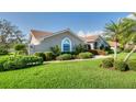 Beautiful front yard featuring a well-manicured lawn and professionally landscaped bushes and shrubbery at 1611 Valley Dr, Venice, FL 34292