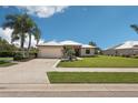 Inviting single-story home boasting a well-manicured lawn, palm trees, metal roof, and a spacious two-car garage at 19893 Cobblestone Cir, Venice, FL 34292