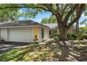 Charming single-story home featuring a lush yard, mature trees, and a two-car garage at 226 Southampton Ln # 257, Venice, FL 34293