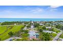 Panoramic aerial view of neighborhood near ocean, highlighting nearby lush green park at 304 Beach Rd, Venice, FL 34285