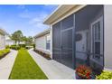 Welcoming screened entry featuring a wreath, pretty flower pot, and a well-manicured walkway at 3419 Lakewood Blvd, North Port, FL 34287