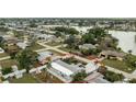 Aerial view showcasing the home's location within a neighborhood near a tranquil lake at 379 Peppertree Rd, Venice, FL 34293