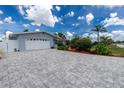 Attractive single-story home featuring a paved driveway, two-car garage and landscaped yard at 379 Peppertree Rd, Venice, FL 34293