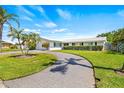 Charming single-story home featuring a circular driveway and well-manicured landscaping at 4255 13Th Ne Ln, St Petersburg, FL 33703