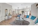 Elegant living room with wood floors, arched windows, stylish decor, and comfortable furnishings at 4321 Via Del Santi Dr, Venice, FL 34293