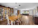 Cozy dining area adjacent to the living room, featuring hardwood floors and a built-in bookcase at 4531 Crystal Rd, Venice, FL 34293