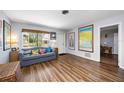 Inviting living room featuring hardwood floors, a comfortable sofa, and natural light from a large window at 4531 Crystal Rd, Venice, FL 34293