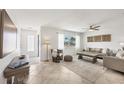 Inviting living area with a ceiling fan, tile flooring, comfortable seating, and natural light at 507 Buena Vista Dr, Nokomis, FL 34275