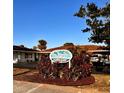 Sign for Sea Breeze Cottages with lush landscaping and an inviting facade in the background at 510 Airport E Ave # 2C, Venice, FL 34285