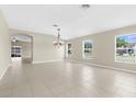 Spacious living room with tile floors, neutral walls, recessed lighting, and plenty of natural light at 5255 Layton Dr, Venice, FL 34293