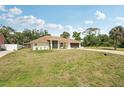 Charming single-story home with manicured lawn and mature trees in a quiet neighborhood at 5417 Maccaughey Dr, North Port, FL 34287