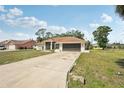 Single-story home with wide driveway and manicured front lawn in a quiet neighborhood at 5417 Maccaughey Dr, North Port, FL 34287