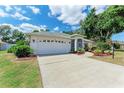 Beautifully landscaped single-story home with a two-car garage, screen porch, and inviting curb appeal at 5766 Stone Pointe Dr, Sarasota, FL 34233