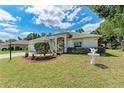 Well-kept single-story home with a manicured lawn, decorative front yard, and lovely curb appeal at 5766 Stone Pointe Dr, Sarasota, FL 34233