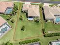 Expansive backyard and lush green space is surrounded by a red property outline at 615 May Apple Way, Venice, FL 34293