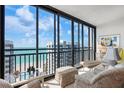 Bright living room with floor-to-ceiling windows and ocean view from the condo at 627 Alhambra Rd # 1103, Venice, FL 34285