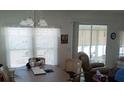 Inviting dining room with bright windows and comfortable seating adjacent to the living area at 638 Leisure, Venice, FL 34285