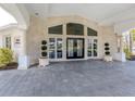 Grand home entrance boasting modern architecture, elegant columns, and manicured plants at 701 Laguna Dr, Venice, FL 34285