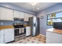 Bright kitchen with stainless steel appliances, white cabinetry, and a window offering natural light at 758 Bird Bay W Dr # 169, Venice, FL 34285