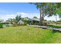 Well-maintained home featuring a large grassy front yard and mature shade trees at 888 Kimball Rd, Venice, FL 34293