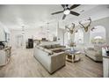 Bright living room with hardwood floors, natural light, and cozy seating creates an inviting atmosphere at 10047 Greetings St, Port Charlotte, FL 33981