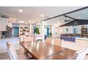 Open floor plan with dining table leading to a modern kitchen and a comfortable living area at 1008 Euclid Rd, Venice, FL 34293