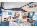 Open concept living room featuring a ceiling fan, multiple sofas, and views to the kitchen and dining area at 1008 Euclid Rd, Venice, FL 34293