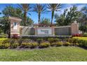 The Venetian Falls entrance displays lush landscaping, a cascading water feature, and impressive signage at 11007 Batello Dr, Venice, FL 34292