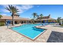 Large community pool with ample seating, ideal for socializing and enjoying recreational activities outdoors at 11007 Batello Dr, Venice, FL 34292