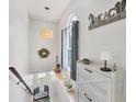 Bright hallway with stylish decor, natural light, and a cozy seating area at 1500 Lemon Bay Dr, Venice, FL 34293