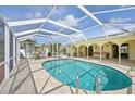 Inviting pool area featuring a large, screened enclosure and ample seating at 1537 Overbrook Rd, Englewood, FL 34223